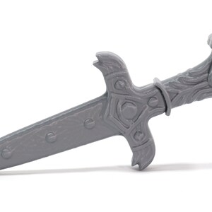 May include: A gray metal dagger with an ornate handle and a pointed blade.