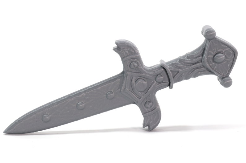 May include: A gray metal dagger with an ornate handle and a pointed blade.
