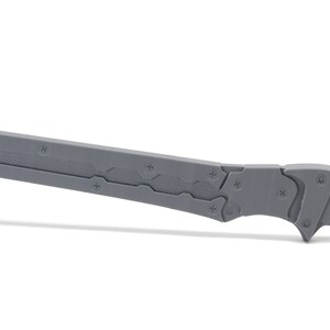May include: A gray metal knife with a textured blade and a black handle. The knife has a sharp point and a serrated edge.