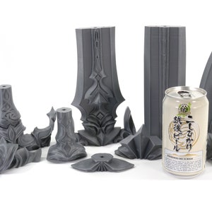 May include: A set of 3D printed gray plastic pieces that make up a sword. The pieces are arranged on a white surface with a can of Japanese beer in the center.