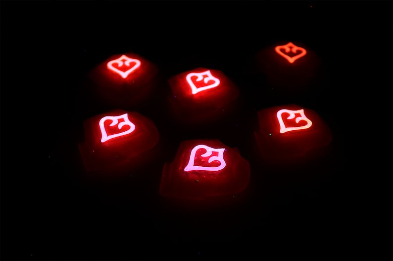 May include: Seven red glowing dice with a white heart symbol on each face. The dice are arranged in a circle on a black background.