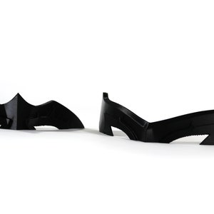 May include: Two black plastic masks, one shaped like a bat and the other with a more angular design.
