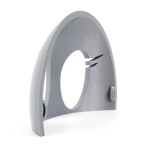 May include: A gray 3D printed plastic half dome with a circular opening in the center. The dome has a smooth, textured surface.