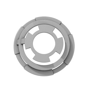 May include: A silver metal washer with a circular shape and a central hole. The washer has a series of concentric rings and a starburst pattern.