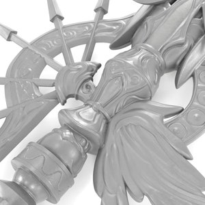 May include: A silver-colored metal sculpture with intricate details, featuring a central figure with wings and a circular base with spikes.