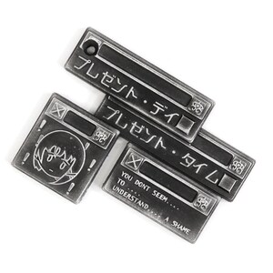 May include: Three silver metal keychains with Japanese text that reads "Present Day" and "Present Time". The third keychain has the text "You don't seem... to understand... A shame".