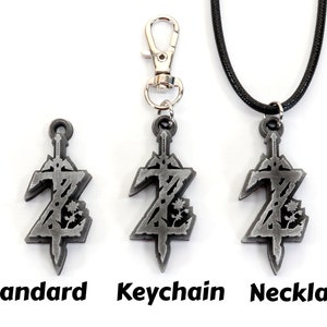 May include: Three versions of a silver-colored pendant featuring a stylized sword and the letter Z. The pendant is available as a standard charm, a keychain, and a necklace.