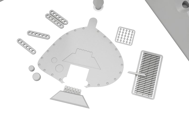 Puede incluir: Un conjunto de piezas de modelo de pl&aacute;stico gris para un kit de maquetas. Las piezas incluyen una pieza grande, curva, con un recorte, una pieza rectangular m&aacute;s peque&ntilde;a con un dise&ntilde;o en relieve y varias piezas rectangulares m&aacute;s peque&ntilde;as con agujeros.