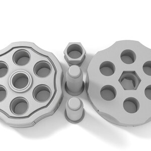 May include: A silver-colored revolver cylinder with six chambers, a hexagonal center, and two separate caps.