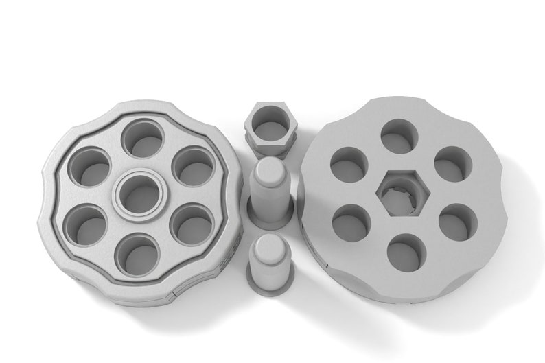 May include: A silver-colored revolver cylinder with six chambers, a hexagonal center, and two separate caps.