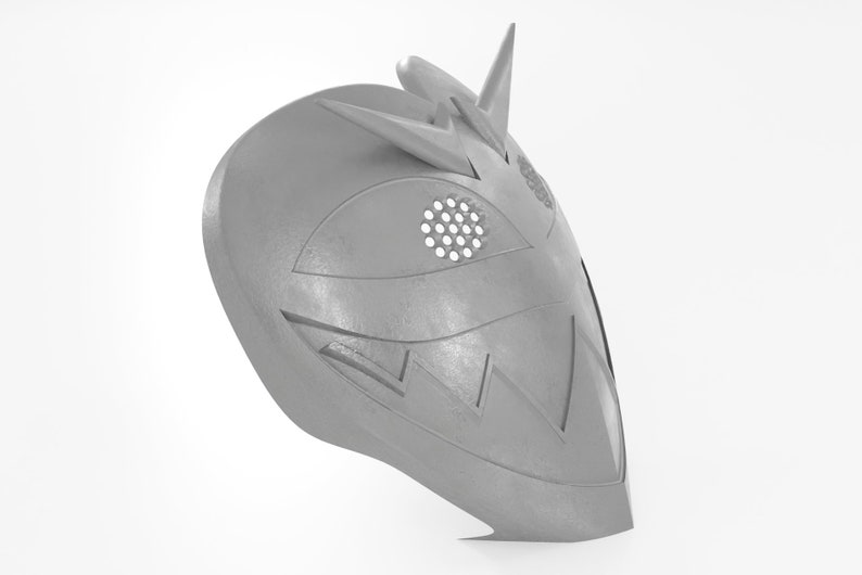 May include: A gray, 3D printed mask with a geometric design. The mask has a pointed top and a wide, open mouth. The eyes are covered with a mesh material.