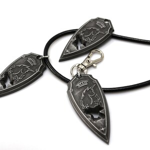 May include: Three silver-toned pendants with a unicorn design, one on a black leather cord, and two with a silver-toned clasp.