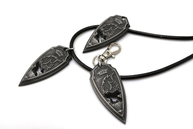 May include: Three silver-toned pendants with a unicorn design, one on a black leather cord, and two with a silver-toned clasp.