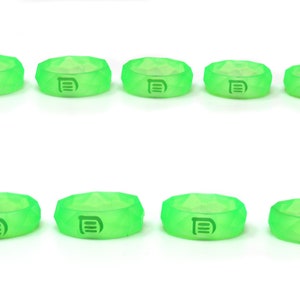 May include: Ten green silicone rings with a raised letter "D" on each ring.