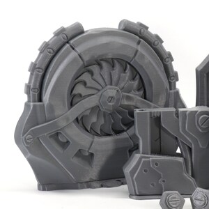 May include: A set of 3D printed gray plastic parts for a robot or machine. The parts include a large fan-like wheel, a smaller rectangular piece with a screw, and a flat piece with a raised design.