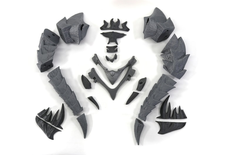 May include: A set of 12 gray plastic pieces that can be assembled into a dragon figurine. The pieces are detailed with scales and spikes.