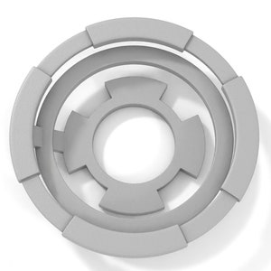 May include: A gray, circular, geometric design with concentric rings and a central starburst shape.
