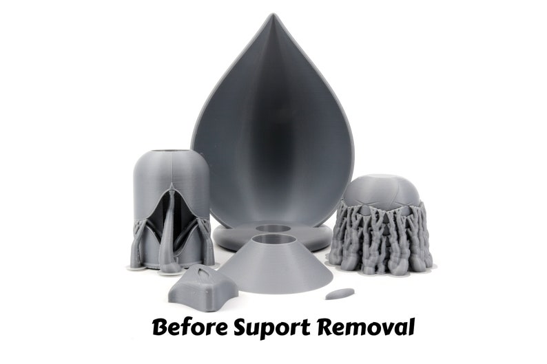 May include: Gray 3D printed objects, including a teardrop-shaped object, a cone-shaped object, and two objects with intricate details. The text "Before Support Removal" is visible at the bottom of the image.