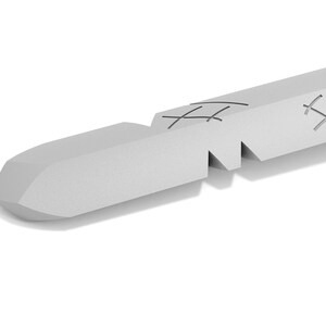 May include: A close-up of a silver-colored, broken, metal rod with a pointed tip. The rod has a series of small, evenly spaced, horizontal cuts along its length.