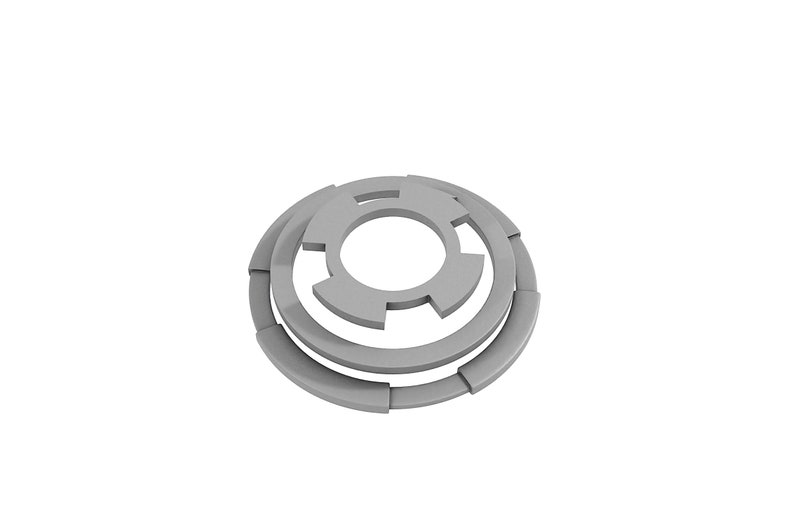 May include: A silver metal washer with a circular shape and a series of concentric rings. The washer has a central hole and a series of cutouts around the outer edge.