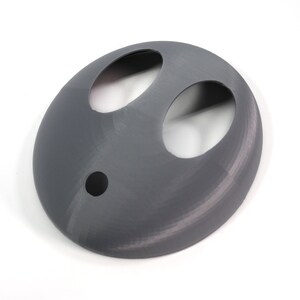 May include: A gray 3D printed mask with two large oval cutouts and a smaller round cutout in the center.