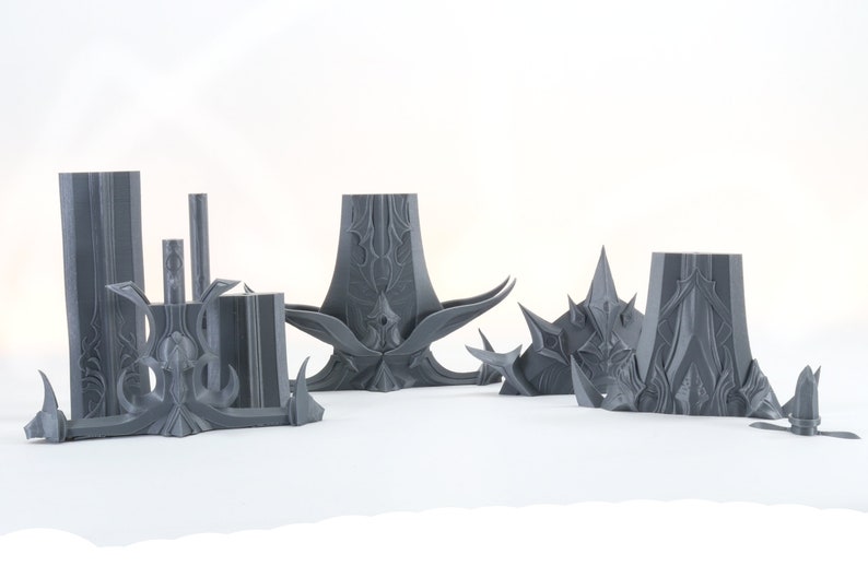 Puede incluir: Un conjunto de cinco piezas de pl&aacute;stico gris impresas en 3D, que se asemejan a un castillo o fortaleza de fantas&iacute;a. Las piezas est&aacute;n detalladas con dise&ntilde;os intrincados y puntas afiladas.
