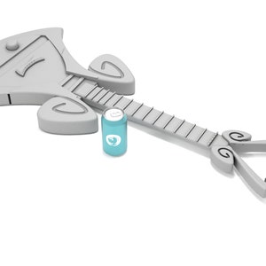 May include: A gray, stylized guitar with a unique design, lying on a white surface. A blue can with a white logo is next to the guitar.
