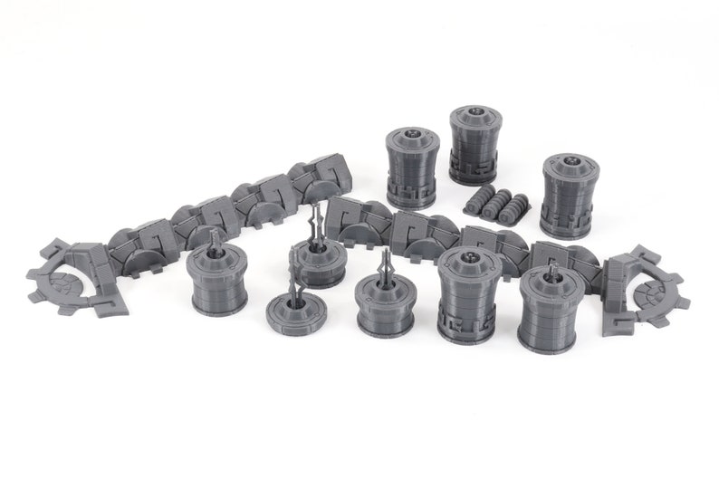 May include: A set of gray 3D printed miniature buildings and walls for a tabletop game or diorama. The set includes a variety of shapes and sizes, including towers, walls, and gates.