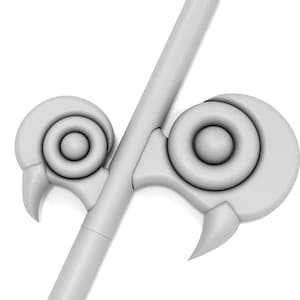 May include: A white, stylized, decorative spearhead with two circular, ring-like protrusions on each side.