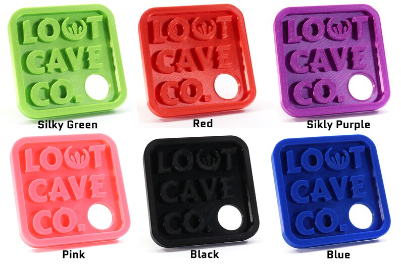 May include: Six square-shaped keychains with the text "LOOT CAVE CO." in raised letters. The keychains are available in six colors: silky green, red, silky purple, pink, black, and blue.