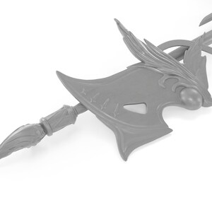May include: A gray, detailed, decorative axe with a long handle and a sharp point. The axe head has a wing-like design and a round knob on the top.