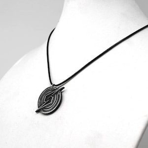 May include: A black necklace with a silver pendant featuring a stylized lightning bolt design.