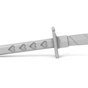 May include: A gray plastic toy sword with a handle decorated with four heart shapes.