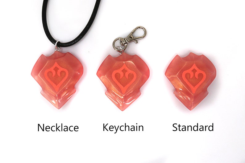 May include: Three versions of a pink and orange resin pendant with a stylized heart design. The pendant is available as a necklace, keychain, or standard.
