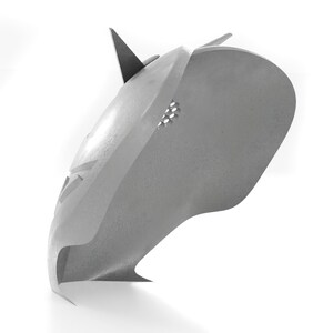 May include: A gray metal helmet with a pointed top and a small hole on the side.