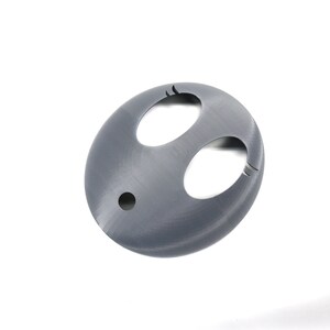 May include: A gray plastic 3D printed object with two oval-shaped cutouts and a small round hole in the center.