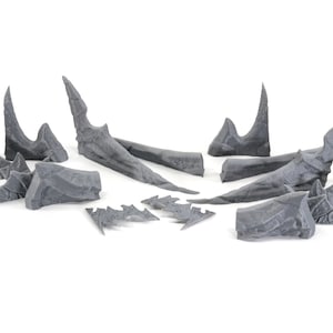 May include: A set of 10 grey plastic dragon wings, ideal for adding a fantasy touch to your miniature models or crafts.