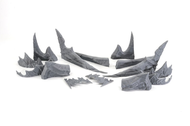 May include: A set of 10 grey plastic dragon wings, ideal for adding a fantasy touch to your miniature models or crafts.