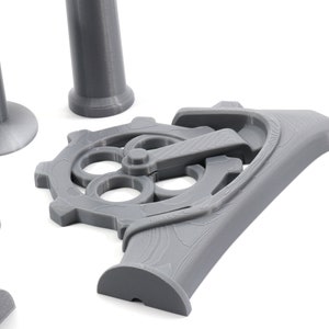 May include: A set of gray 3D printed gears and pipes. The gears have a detailed design with multiple holes and a lever.