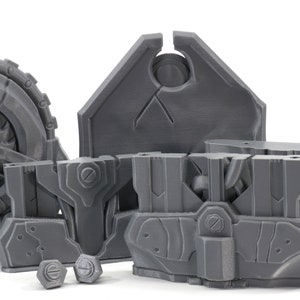 May include: A set of gray 3D printed plastic pieces for a model kit. The pieces include a large wheel with a fan, a shield, and several smaller pieces.