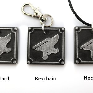 May include: Three versions of a silver metal keychain charm featuring an anvil design. The charm is available as a standard charm, a keychain, and a necklace.
