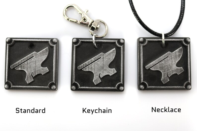 May include: Three versions of a silver metal keychain charm featuring an anvil design. The charm is available as a standard charm, a keychain, and a necklace.