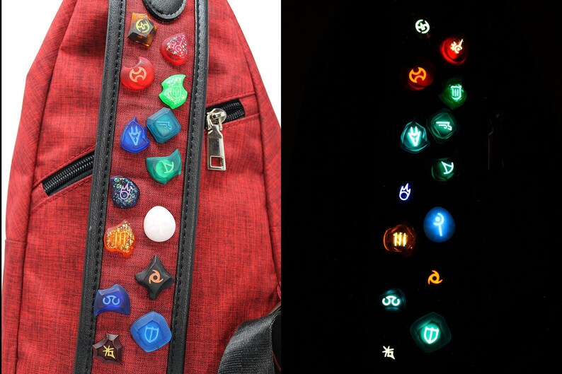 May include: A red backpack with a black strap and a row of glowing, colourful, circular pins with various symbols. The pins glow in the dark.