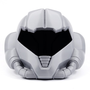 May include: A gray plastic helmet with a visor and a detailed design. The helmet has a futuristic look and is reminiscent of a space suit.