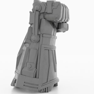 May include: A gray 3D printed model of a robotic hand with a closed fist. The hand is detailed with intricate mechanical parts and a textured surface.