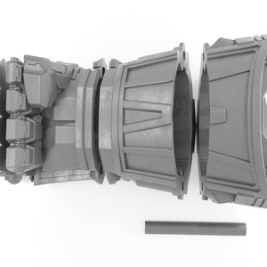 May include: A gray 3D printed model of a robotic hand, disassembled into three parts. The hand is closed into a fist, and the forearm is split into two sections. A gray rod is included.