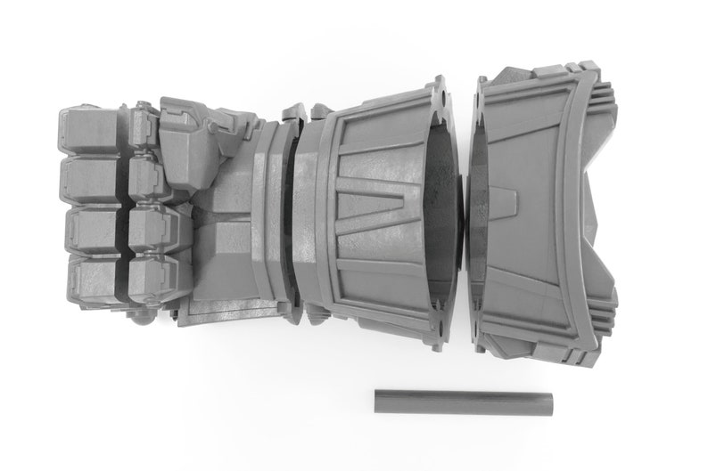 May include: A gray 3D printed model of a robotic hand, disassembled into three parts. The hand is closed into a fist, and the forearm is split into two sections. A gray rod is included.