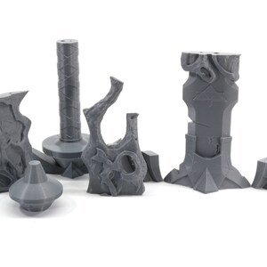 May include: A set of six gray 3D printed miniature dungeon pieces, including a pillar, a tree stump, a wall, and a broken wall.