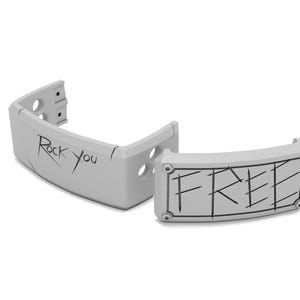 May include: Two light gray, curved, plastic pieces. One piece has the text "Rock you" in black, the other piece has the word "FREE" in black. Both pieces have a few holes and are on a white background.
