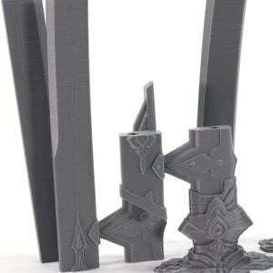 May include: Four grey 3D printed sword blades with intricate details. The blades are in various stages of completion, with some having handles and others just the blade.